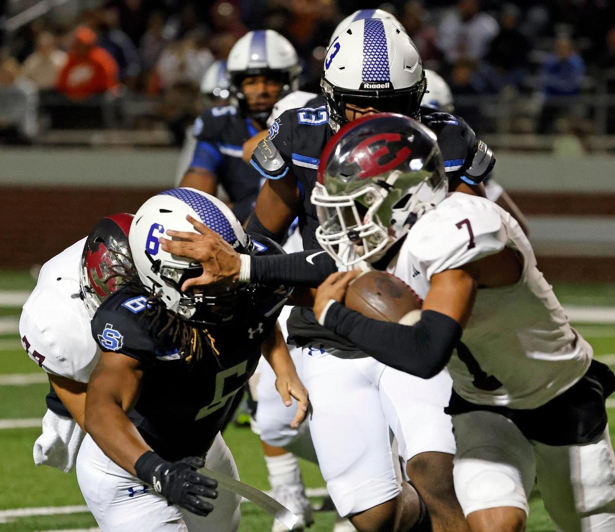 Ennis quarterback Wondame Davis (7) stiff arms Summit’s Kyland Reed in the second half of a UIL football game at Vernon Newsom Stadium in Mansfield, Texas, Friday, Nov. 03, 2023. Summit defeated Ennis 28-21. (Special to the Star-Telegram Bob Booth)