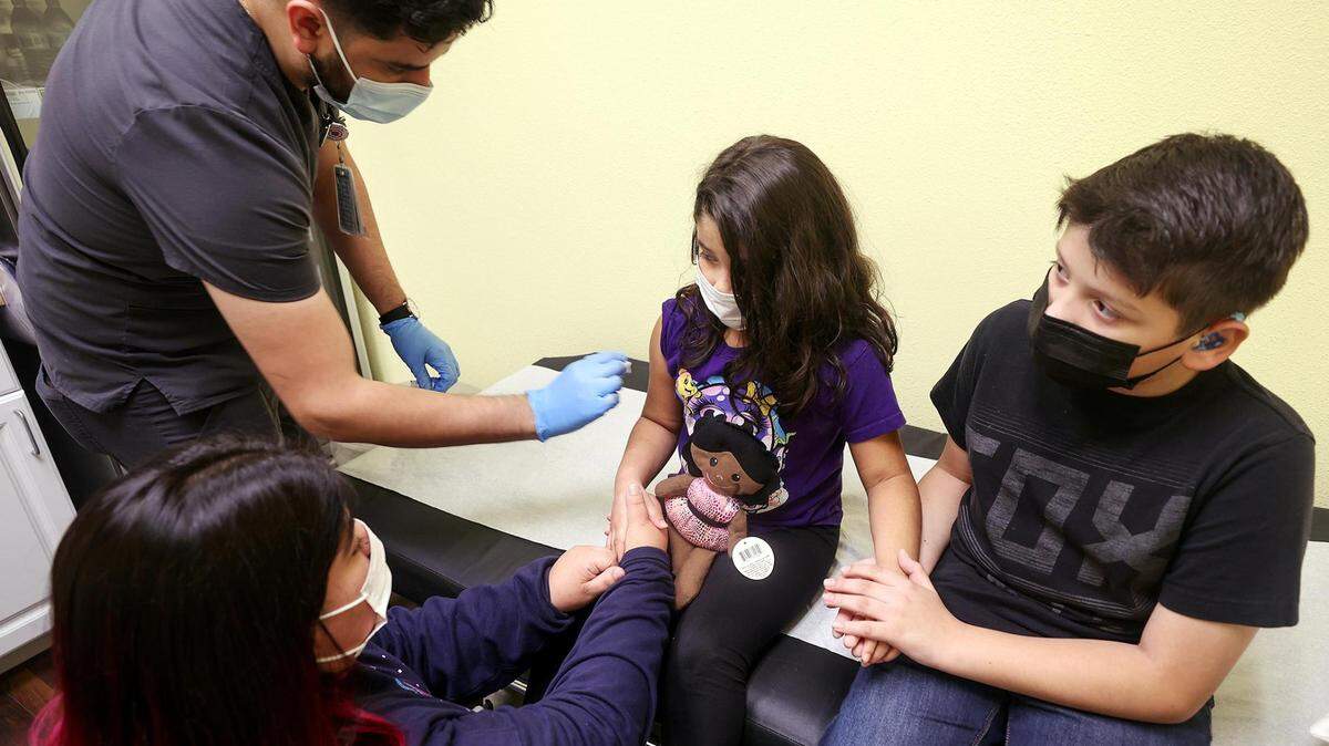 Nurse Adrian Rodriguez gives Hailey Hicks, 6, her first dose of the pediatric COVID-19 while her brother, Daniel Hicks, 12, right, and mother, Ester Hicks, hold her hands for support in this November 2021 file photo. Texas lawmakers filed multiple bills that spread incorrect information about the COVID-19 vaccine during the 2023 legislative session.
