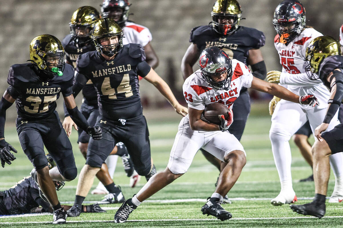 Mansfield Legacy running back J-Uan Harrison Jr. runs through  the Mansfield defense in Friday’s game at Vernon Newsom Stadium. Special to the Star-Telegram / Tom Marvin