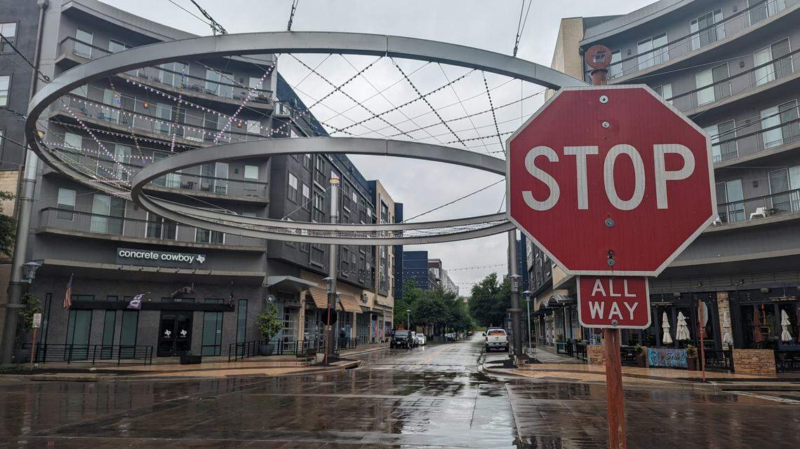 A stop sign at an intersection in Fort Worth's Crockett Row development on a rainy day. 