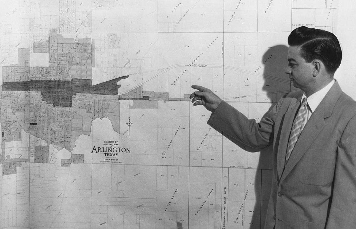 Early 1950s: Mayor Tom Vandergriff showing a map location of the future site of the General Motors assembly plant in Arlington.
