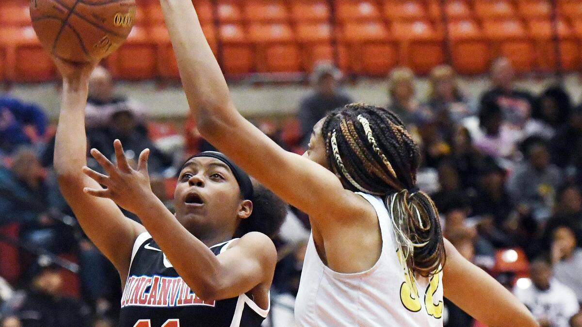 Duncanville’s Tristen Taylor, left takes the jump shot as Desoto’s Tionna Herron defends near in the third period of their Regional Quarterfinal Playoff basket ball game Tuesday, February 25, 2020 at Wilkerson Greines Activity Center in Fort Worth. Texas. Special/Bob Haynes