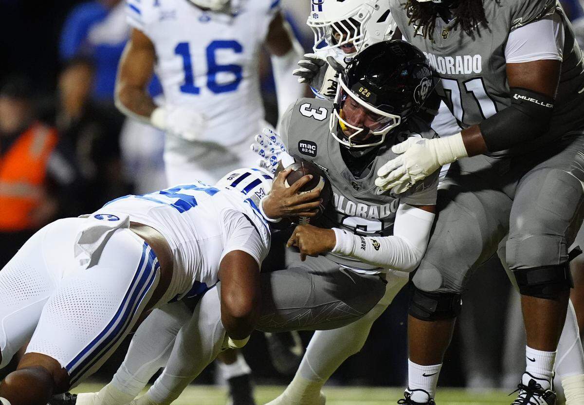 Sep 27, 2025; Boulder, Colorado, USA; Colorado Buffaloes quarterback Kaidon Salter (3) scores a touchdown past Brigham Young Cougars defensive end Viliami Po'uha (45) in the first quarter at Folsom Field. Mandatory Credit: Ron Chenoy-Imagn Images