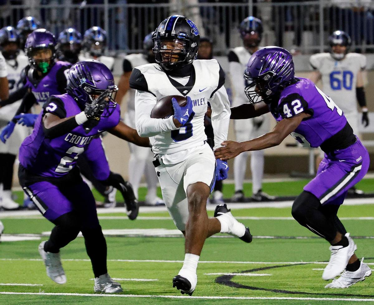 North Crowley running back Ashton Searl (8) steps through the defense of Crowley free safety Donovan Blake (2) and free safety Ladanian Goffney (42) in the first half of a UIL high school football game at Crowley ISD Multi-Purpose Stadium in Fort Worth, Texas, Thursday, Nov. 02, 2023.