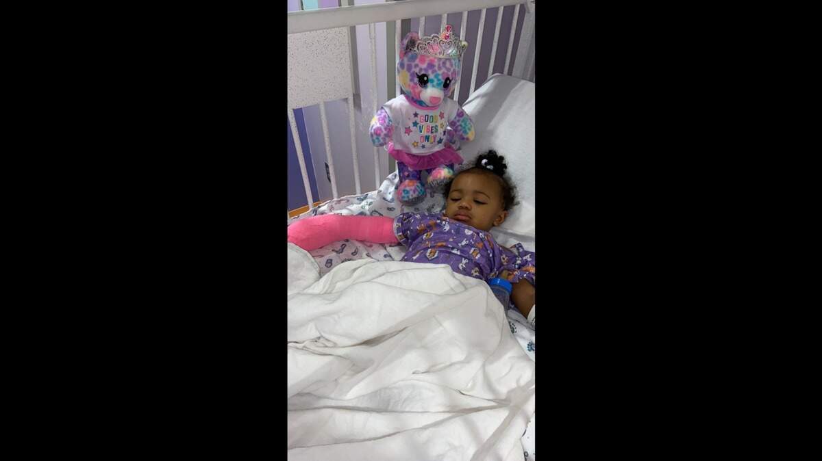 Tamika Wesley’s 1-year-old granddaughter lies in a hospital bed with a cast on her right arm after she was shot in the hand during a shooting in Fort Worth, TX on March 9 that killed her father. Wesley said the girl has been recovering at home.