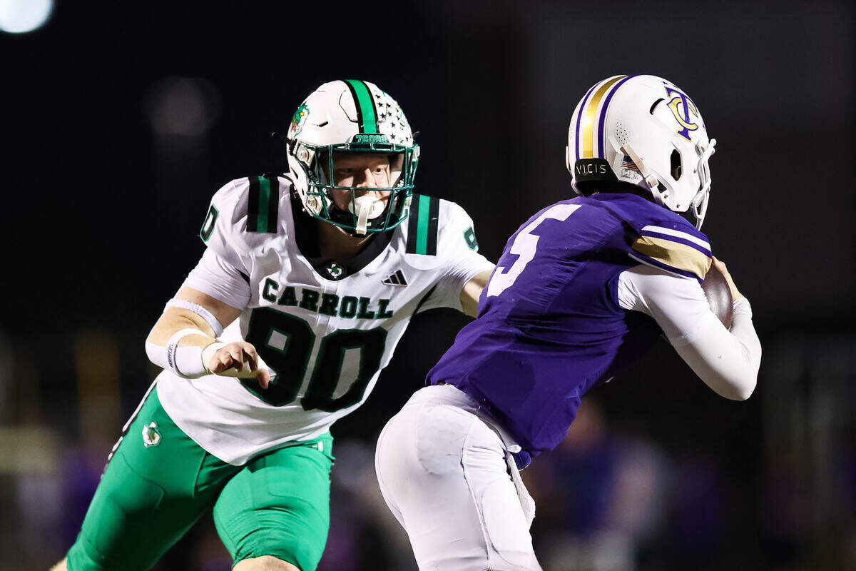 Southlake Carroll defensive lineman Sam Erickson (90) attempts to make a tackle on Keller Timber Creek quarterback Lane Brinkley (5) during a district matchup on Thursday, September 25, 2025 at Keller ISD Stadium in Keller, Texas.
