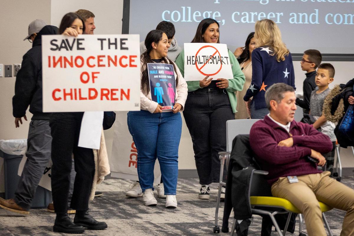 Valeria Nevarez, 22, holds a sign to protest the HealthSmart sexual education curriculum during a school board meeting at the Fort Worth ISD Teaching and Learning Center on Tuesday, Jan. 24, 2023. Nevarez helped organize several dozen concerned citizens and parents to protest HealthSmart, which has supplied the district with its curriculum since 2014, saying the content is “inappropriate” for school-aged children.