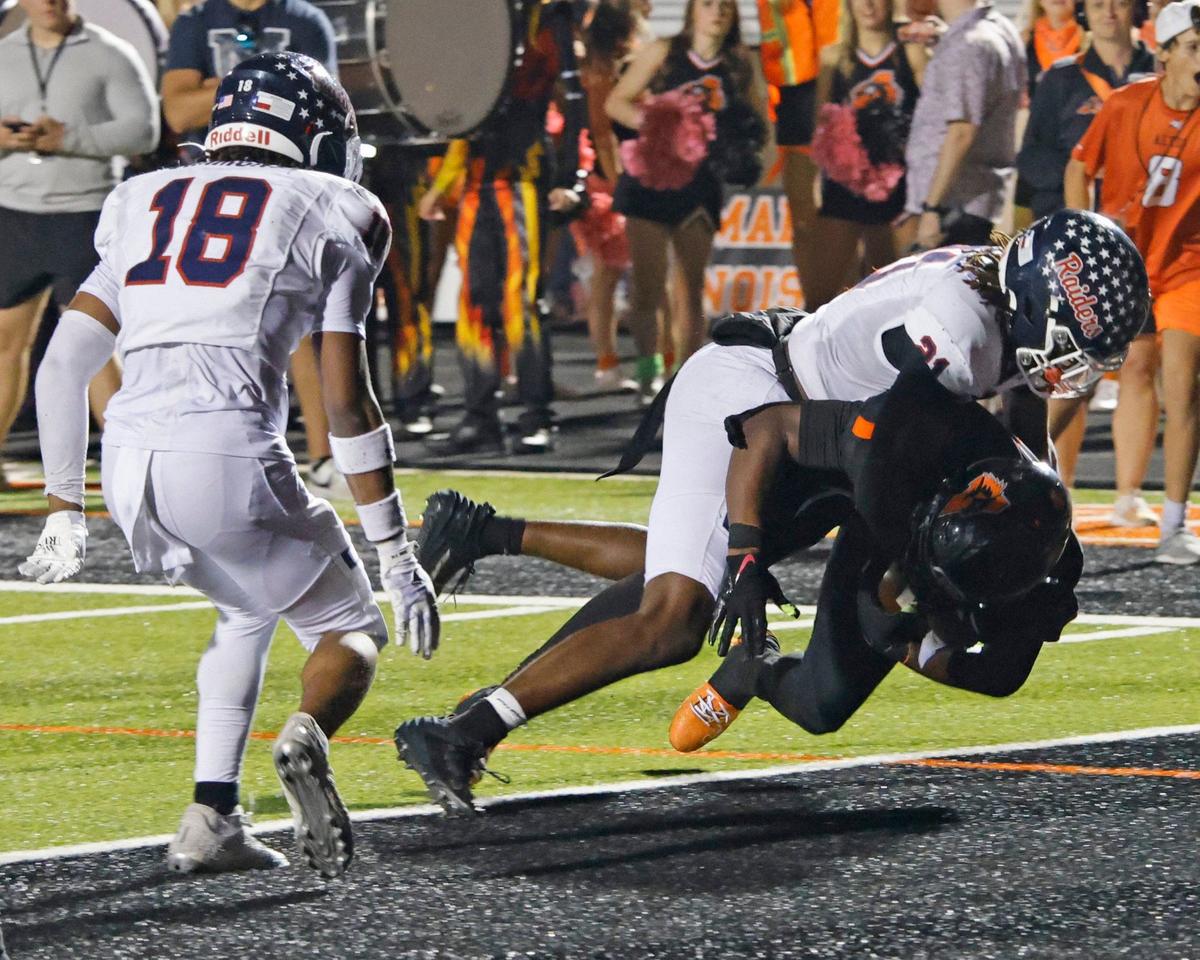 Denton Ryan linebacker Dillon Arkansas (21) rides Aledo running back Racine Guillory (1) into the end zone for the Bearcats go-ahead touchdown during a UIL football game at Buchanan Stadium in Aledo Texas, Friday, Oct. 04, 2024.