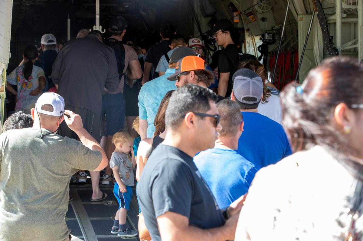 People gather to look inside a military airplane at the Fort Worth Alliance Airport in Fort Worth on Saturday, Oct. 22, 2022. The AllianceTexas Aviation Expo presented by Bell offered interactive and educational opportunities face-to-face with dozens of aircrafts spread across the tarmac.