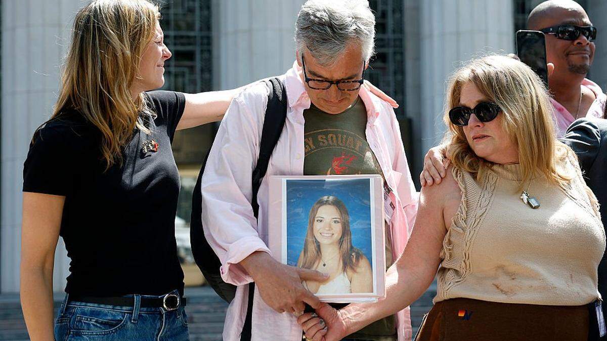 LOS ANGELES, CALIFORNIA - MARCH 25: People hold a photo of a loved oneoutside of the Los Angeles Superior Court on March 25, 2026 in Los Angeles, California. A Los Angeles jury found social media giants Meta and Google liable for designing addictive social media platforms that harmed a young woman's mental health. (Photo by Justin Sullivan/Getty Images)