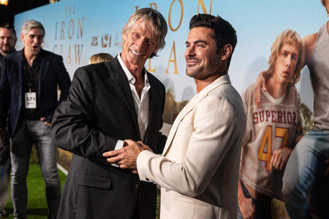 WWE Hall of Fame member Kevin Von Erich greets Actor Zac Efron, who stars as Von Erich in the film, on the red carpet for the world premiere of the movie “The Iron Claw,” at the Texas Theater in Dallas on Wednesday, Nov. 8, 2023.