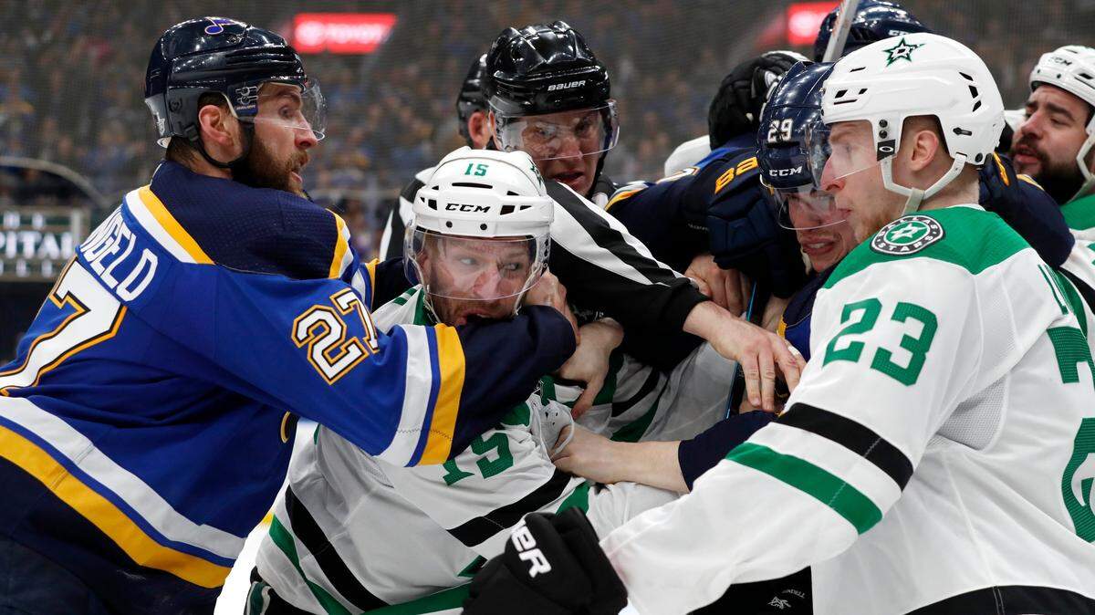St. Louis Blues’ Alex Pietrangelo (27) and Dallas Stars’ Esa Lindell (23) help to break up a fight between the Stars’ Blake Comeau (15) and the Blues’ Vince Dunn (29) during the third period in Game 1 of an NHL second-round hockey playoff series Thursday, April 25, 2019, in St. Louis. (AP Photo/Jeff Roberson)