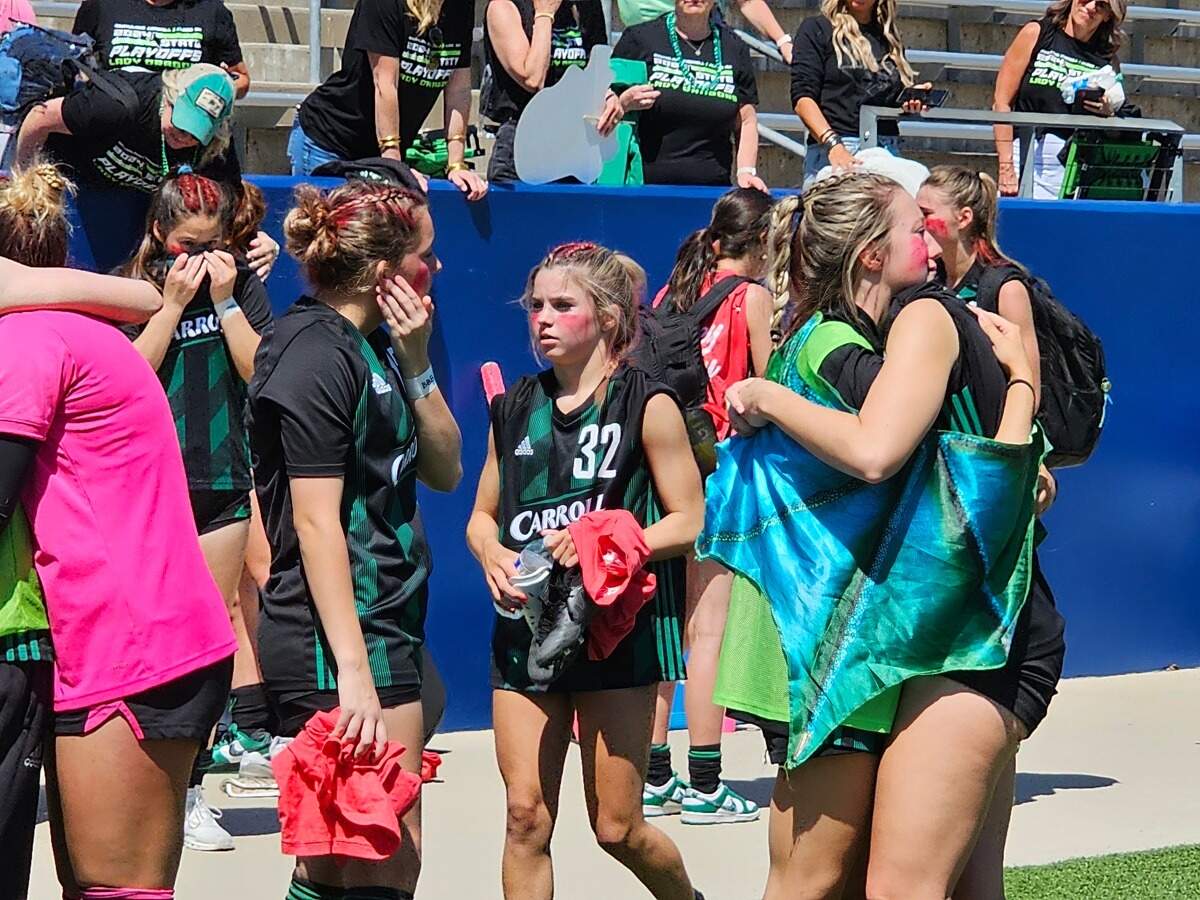 Southlake Carroll girls soccer players embrace following a regional semifinal loss to Prosper at McKinney ISD Stadium on April 5, 2024.