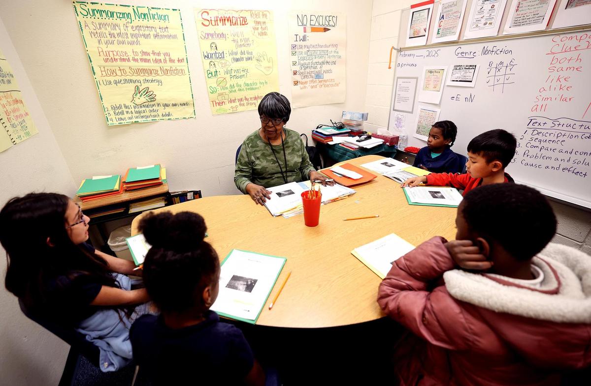 Retired teacher Wanda Mckenzie, center, tutors students at Clifford Davis Elementary School on Feb. 3, 2025. Fort Worth ISD announced Wednesday that it plans to adopt a turnaround model that will mean big changes at Clifford Davis as well as Morningside Middle, William James Middle, Wedgwood Middle, West Handley Elementary, Western Hills Elementary and Western Hills Primary schools.