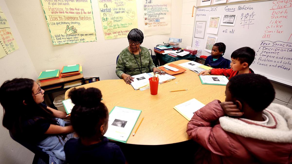 Retired teacher Wanda Mckenzie, center, tutors students at Clifford Davis Elementary School on Feb. 3 in Fort Worth.