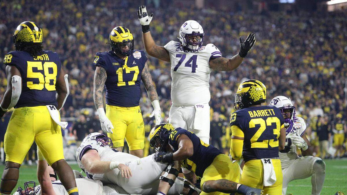 TCU right tackle Andrew Coker signals a touchdown during a pileup at the end zone during the Vrbo Fiesta Bowl at State Farm Stadium in Glendale, Ariz., on Saturday, December 31, 2022.