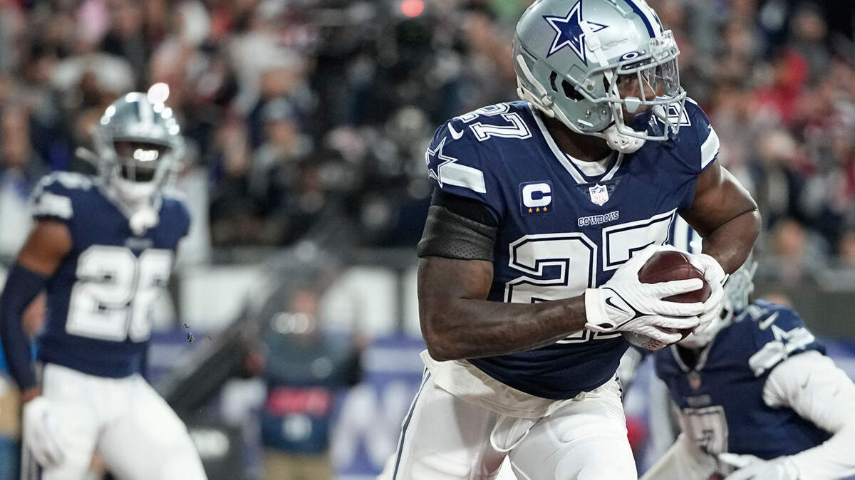 Dallas Cowboys safety Jayron Kearse (27) runs in the end zone after his interception against the Tampa Bay Buccaneers during the first half of an NFL wild-card football game, Monday, Jan. 16, 2023, in Tampa, Fla. (AP Photo/Chris Carlson)