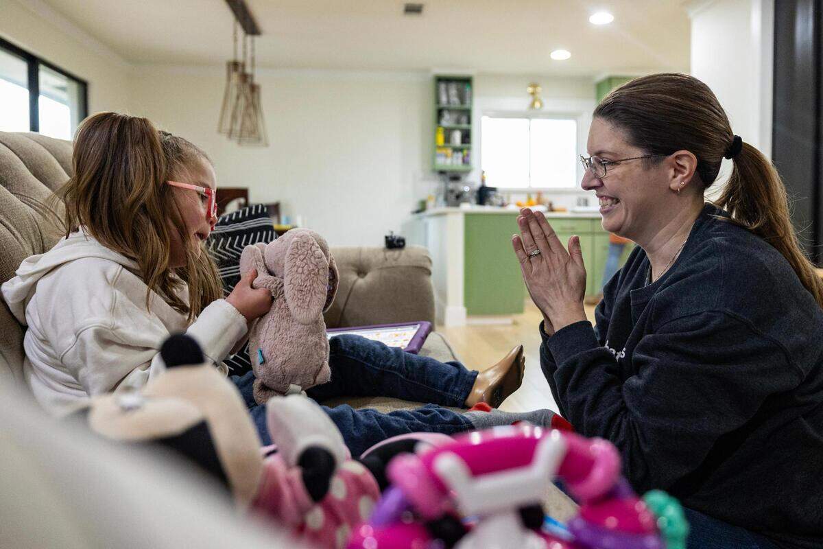 Nora Cerda, 7, and her speech therapist Leanna Vollintine celebrate after completing their session on Jan. 23. Vollintine, along with other speech language pathologists, campaigned to get Blue Cross Blue Shield of Texas to reverse rate cuts for speech language pathology services.