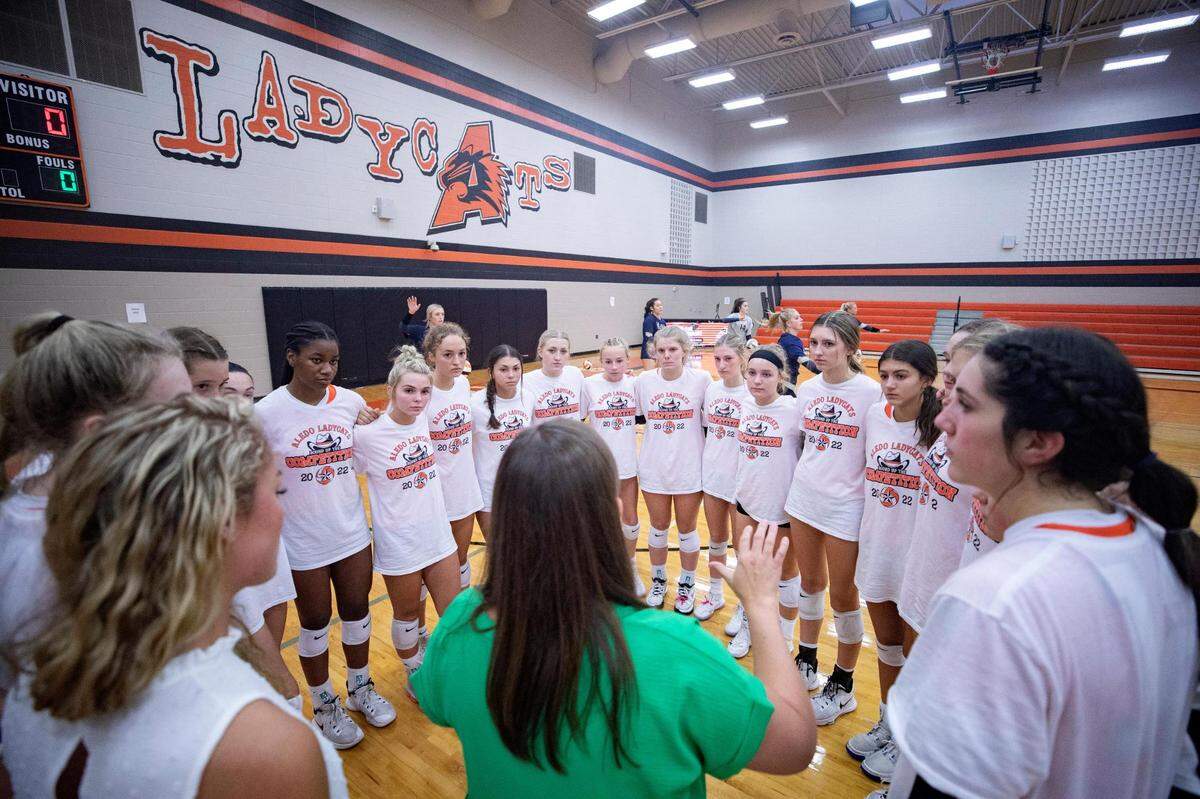The Aledo High School varsity volleyball team huddles before their match against Keller.