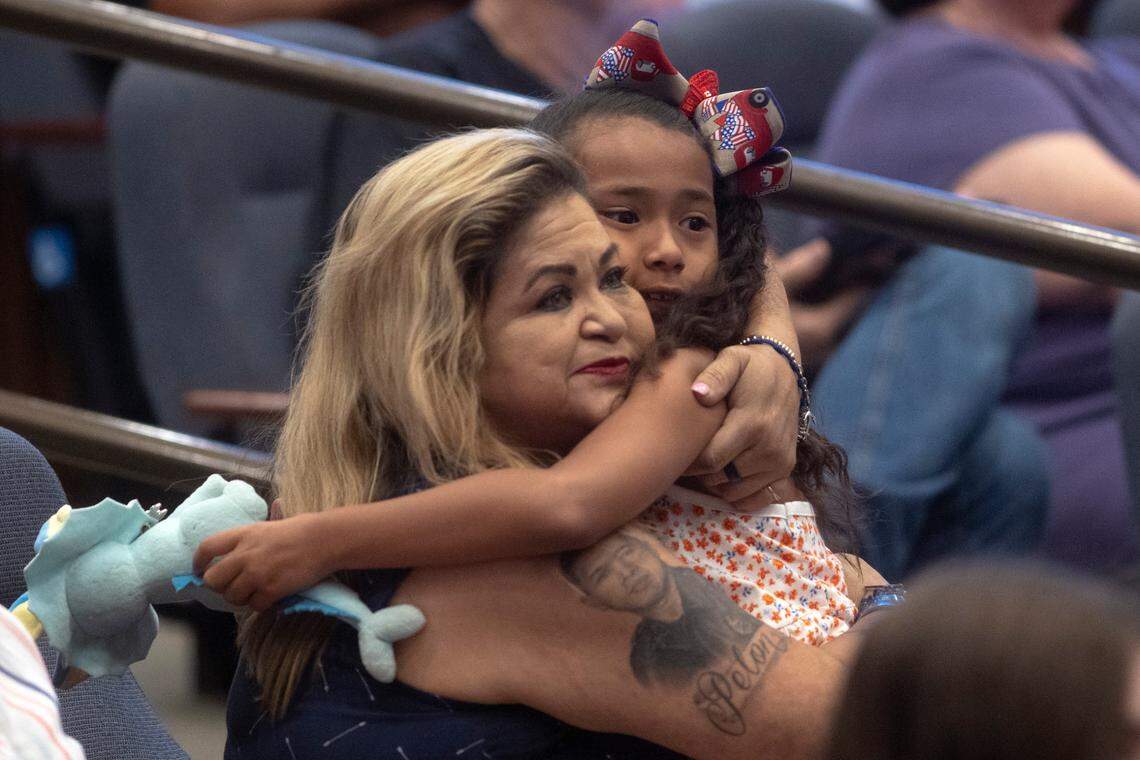 Valerie Zamarripa hugs her granddaughter, Lyncoln, 8, after speaking in support of naming a new baseball complex in Echo Park after her son during the Fort Worth’s City Council meeting on Tuesday, June 14, 2022. Patrick Zamarripa grew up playing baseball at the field and was killed in the line of duty as a Dallas police officer in 2016.