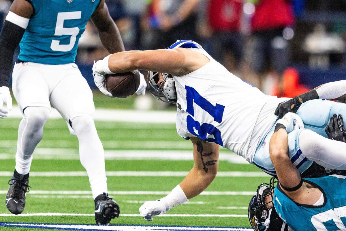 Dallas Cowboys tight end Jake Ferguson (87) dives for a first down during the first preseason game between the Dallas Cowboys and Jacksonville Jaguars at AT&T Stadium in Arlington, Texas on Saturday, Aug. 12, 2023.