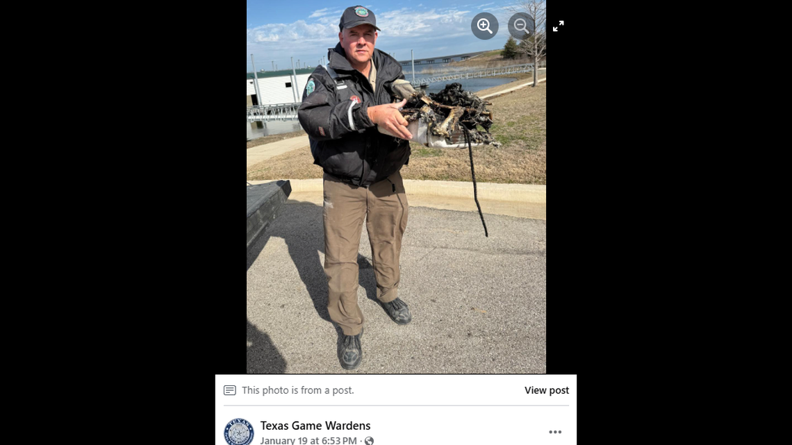 A Texas Game Warden holds the melted remains of the Yeti cooler two stranded hunters used to build a fire in frigid conditions in the middle of a lake.