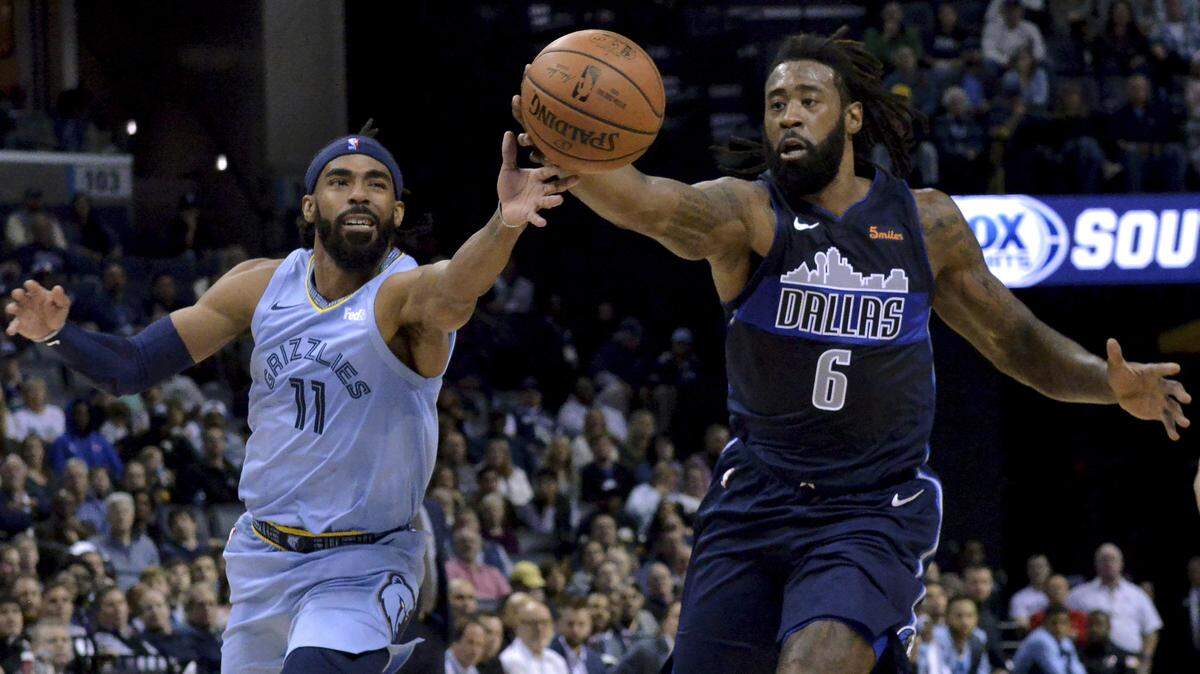 Memphis Grizzlies guard Mike Conley (11) and Dallas Mavericks center DeAndre Jordan (6) struggle for control of the ball in the first half of an NBA basketball game Monday, Nov. 19, 2018, in Memphis.