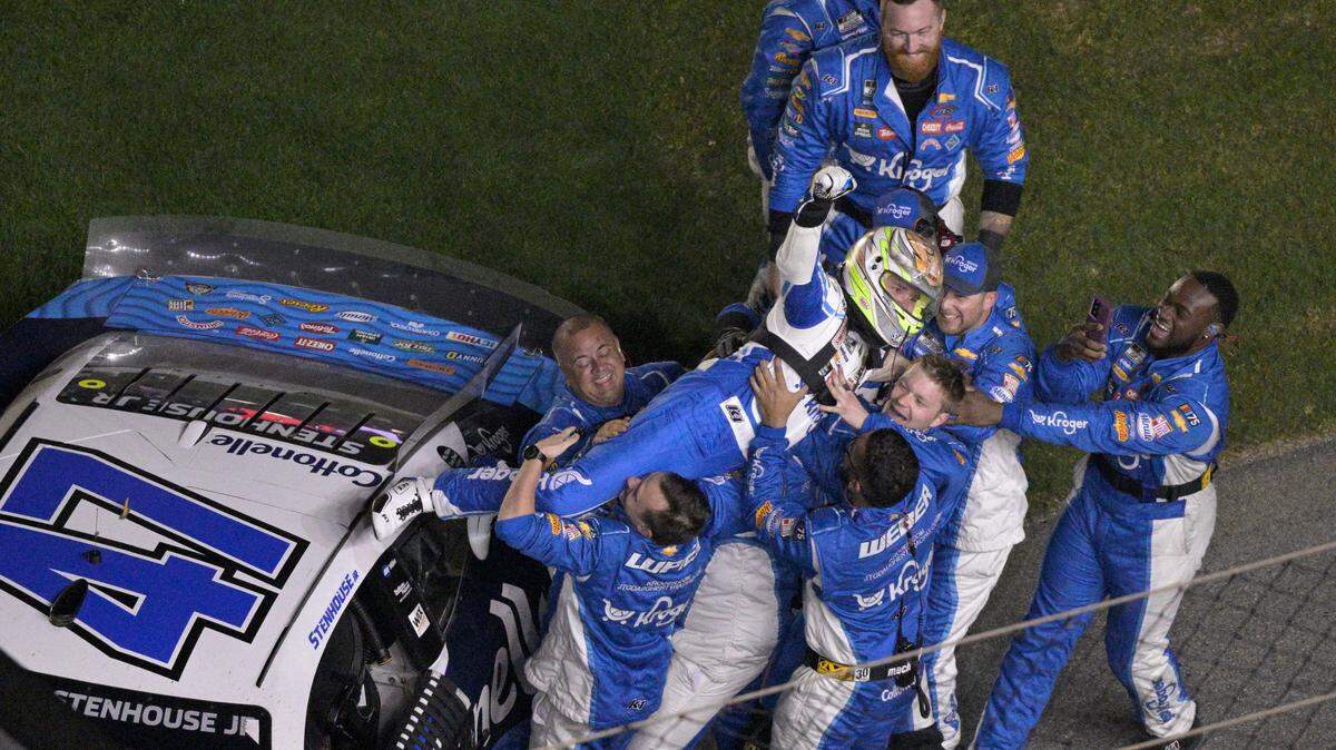 Ricky Stenhouse Jr. dives onto his crew members while celebrating after he won the NASCAR Daytona 500 auto race at Daytona International Speedway, Sunday, Feb. 19, 2023, in Daytona Beach, Fla.