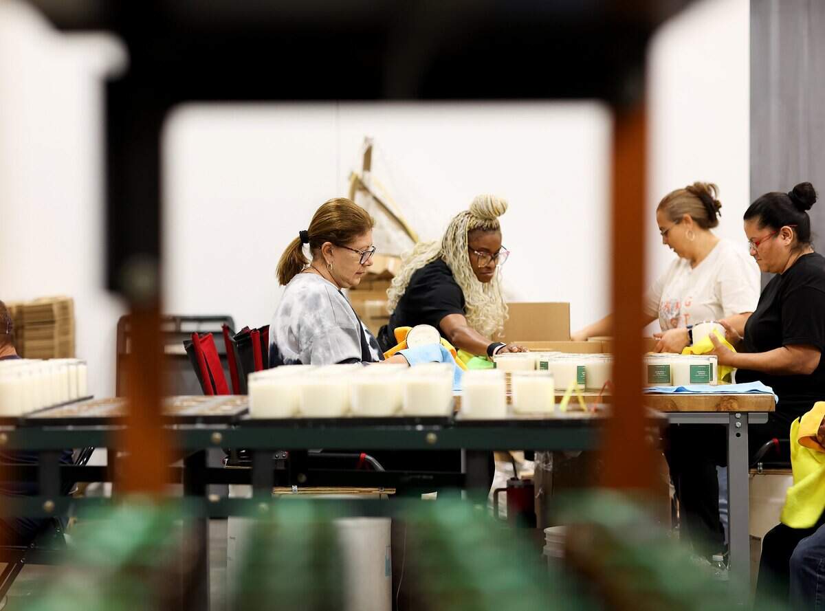 Employees at Calyan Candles finish processing candles at the operational warehouse on Friday, Sept. 12, 2025, in Arlington.