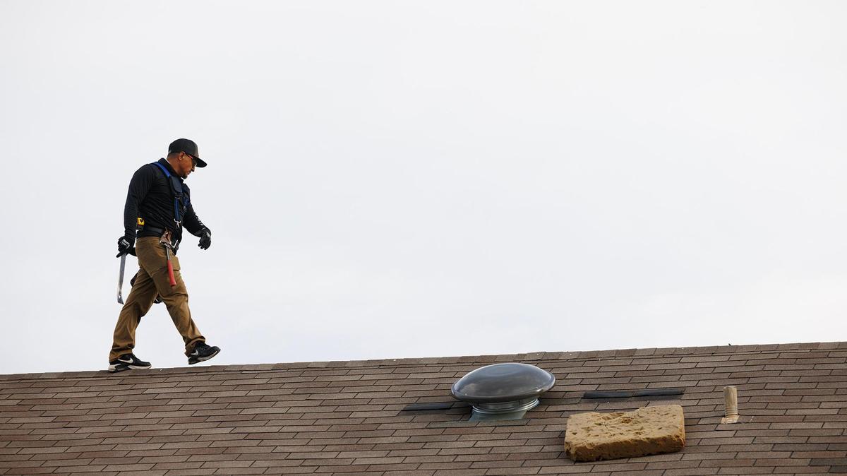 A dude inspects a roof