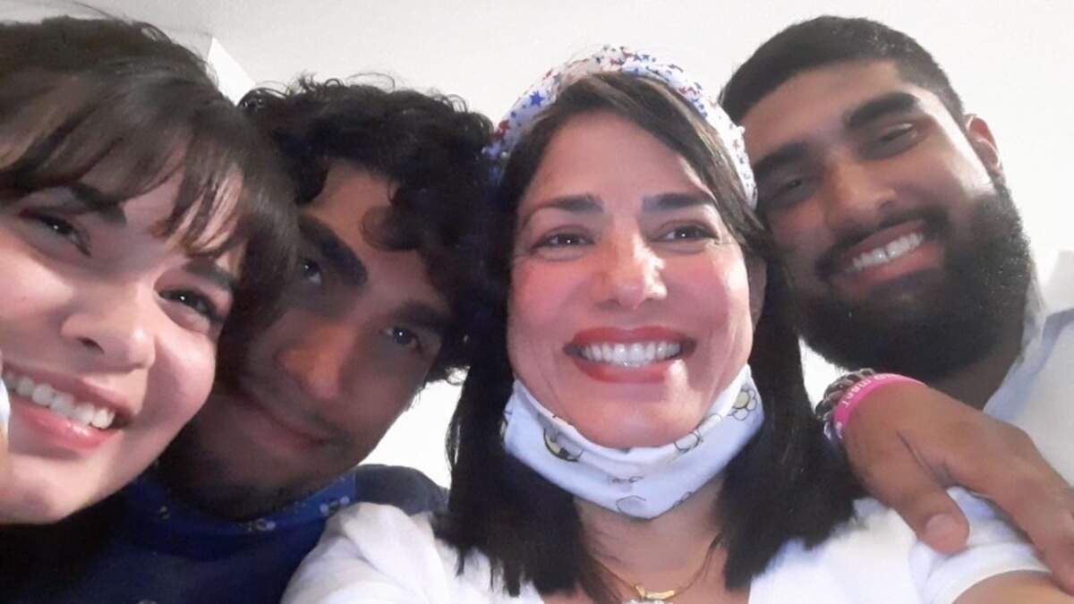 Cousins Pamela Ly Anglero (left), Esteban Vilchez (center left), Tamara Mendoza (center right) and Marco Jr. Vilchez (right) smile for a picture. Tamara, a 46-year-old immigrant from Venezuela, lived with Esteban and Pamela, a couple, over much of the last year.