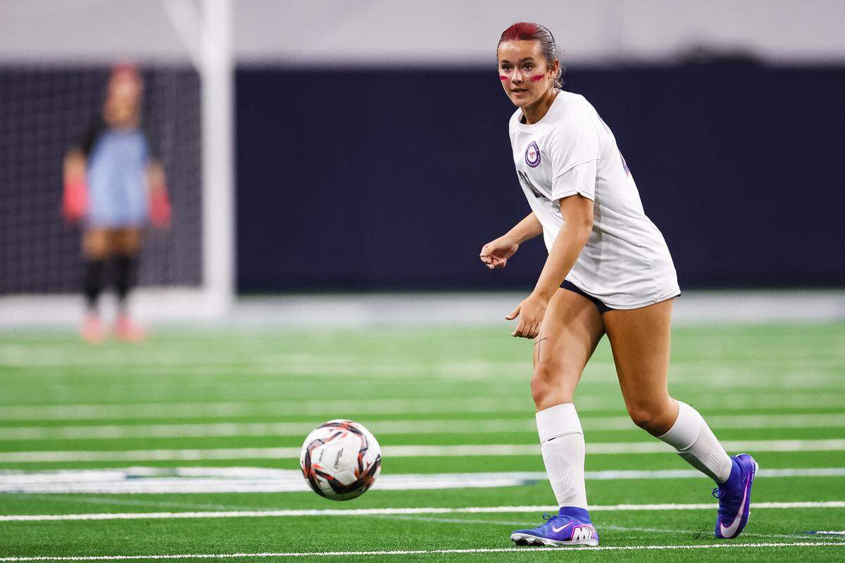 Grapevine midfielder Calleigh Cryer (23) dribbles the ball up the field looking for an open teammate against Frisco Wakeland in a Class 5A Division II UIL girls soccer state semifinal at the Ford Center on April 3, 2026 in Frisco, Texas.