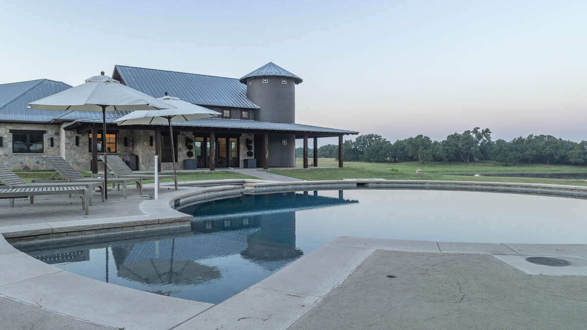 The pool at Bosque Mountain Ranch is surrounded by an entertainment filled pool house and outdoor kitchen pavilion.