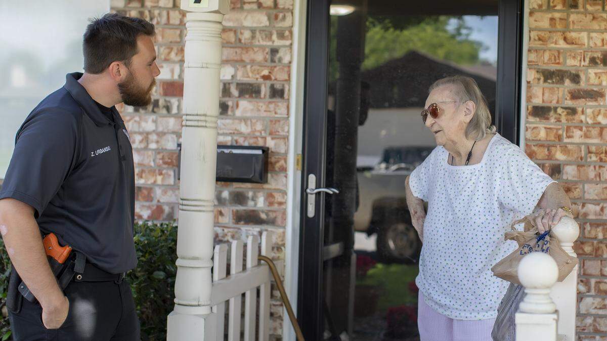 Mansfield Animal Control Officer Zac Urbanski visits with Gertrude Wilson during a Meals on Wheels delivery. The animal control office serves as a a subdivision of the police department, which is assisting Meals on Wheels in its efforts to help the community.