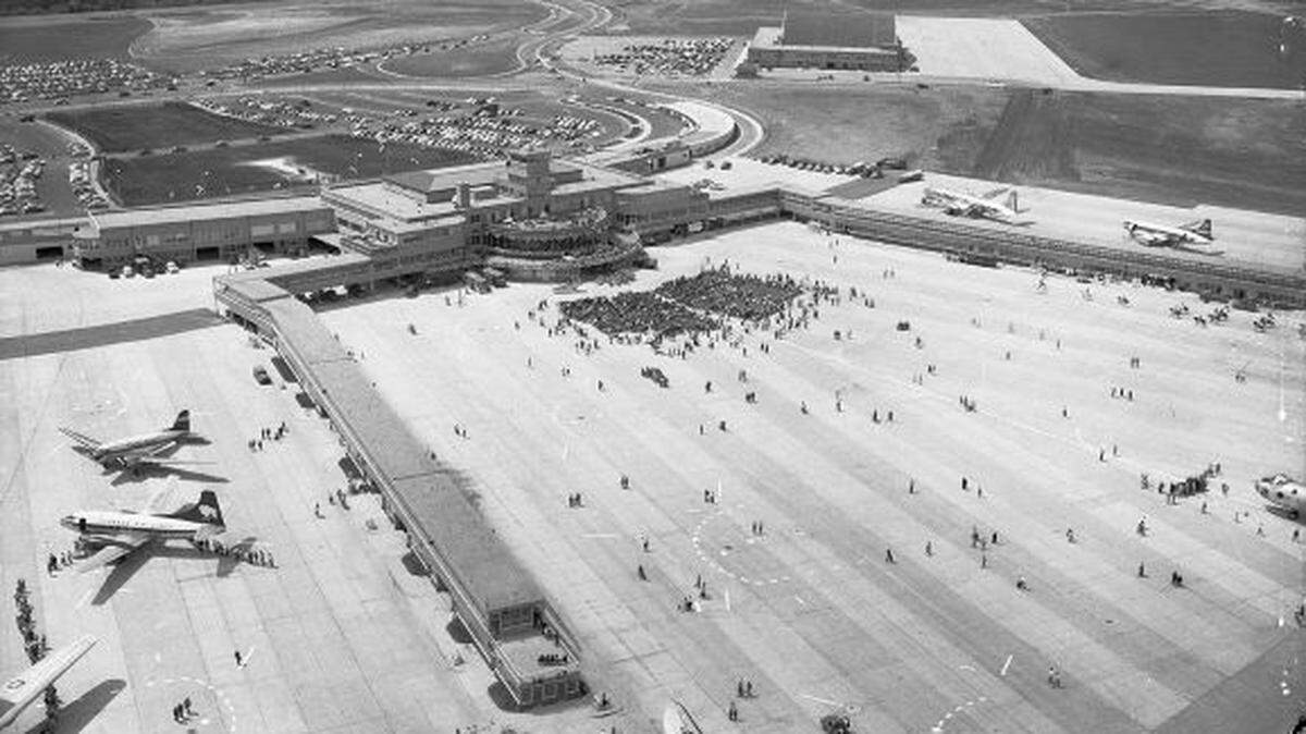 The terminal with its runways and planes parked on the tarmac, with vast undeveloped land in the background.
