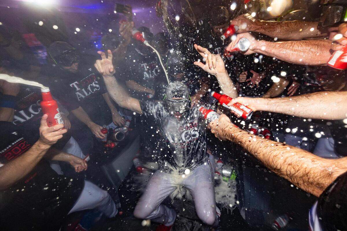 Texas Rangers pitcher Nathan Eovaldi gets beer and champagne poured on him while celebrating a win in game three to clinch the ALDS between the Texas Rangers and Baltimore Orioles at Globe Life Field in Arlington on Tuesday, Oct. 10, 2023.