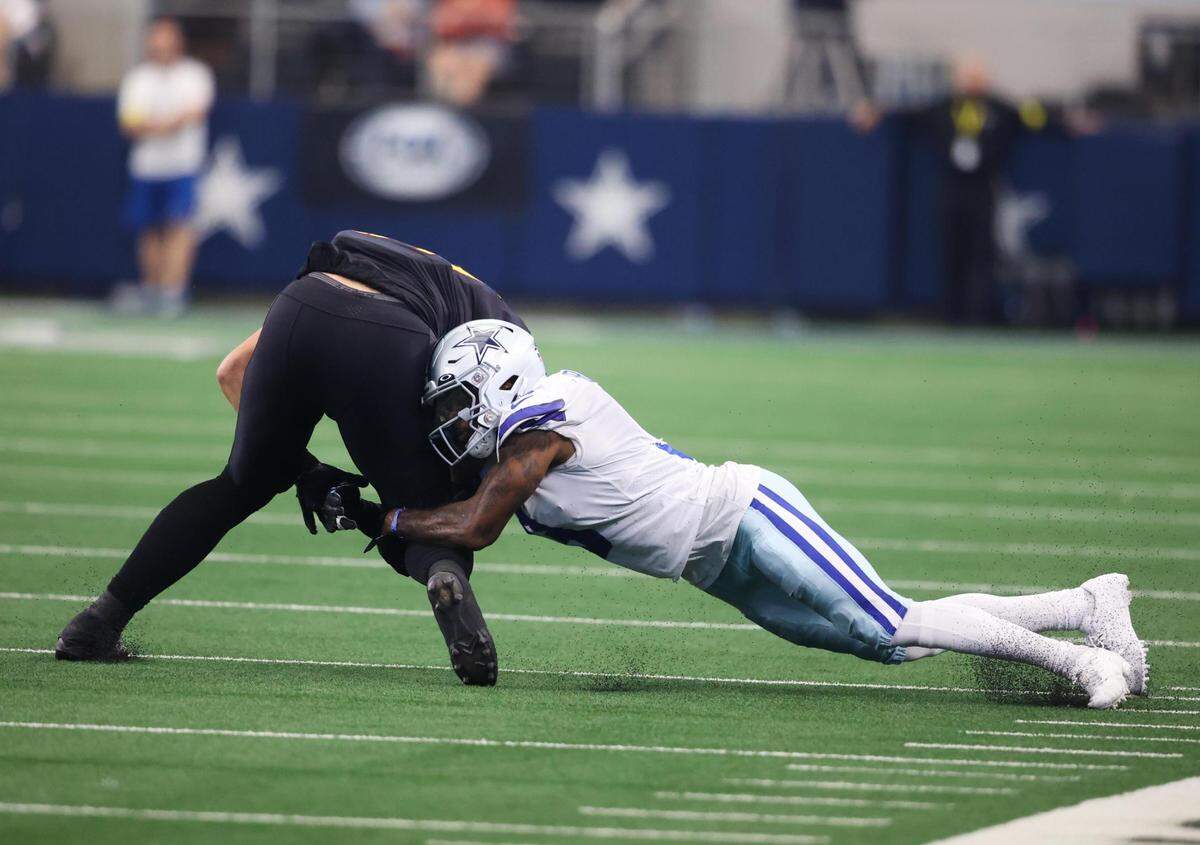 Dallas Cowboys Anthony Brown tackles Washington Commanders on Sunday, Oct. 2, 2022, at AT&T Stadium in Arlington.