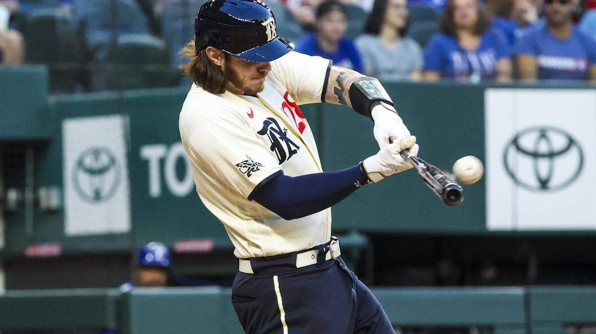 Texas Rangers catcher Jonah Heim (28) hits a three-run home run during the first inning against the Oakland Athletics at Globe Life Field.