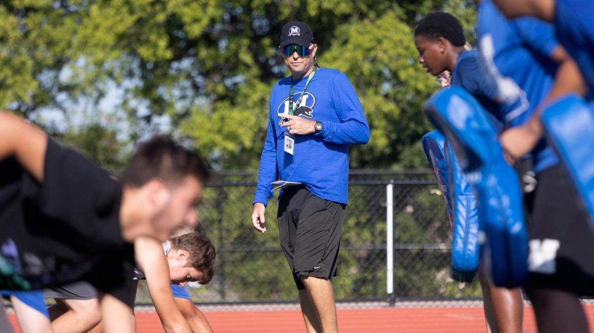 Freshman football coach Clif White runs drills with players during freshman football camp at Midlothian High School on Thursday, July 28, 2022. “Cancer might be overtaking my body, but it’s not overtaking my mind,” said White who is in between rounds of chemotherapy.