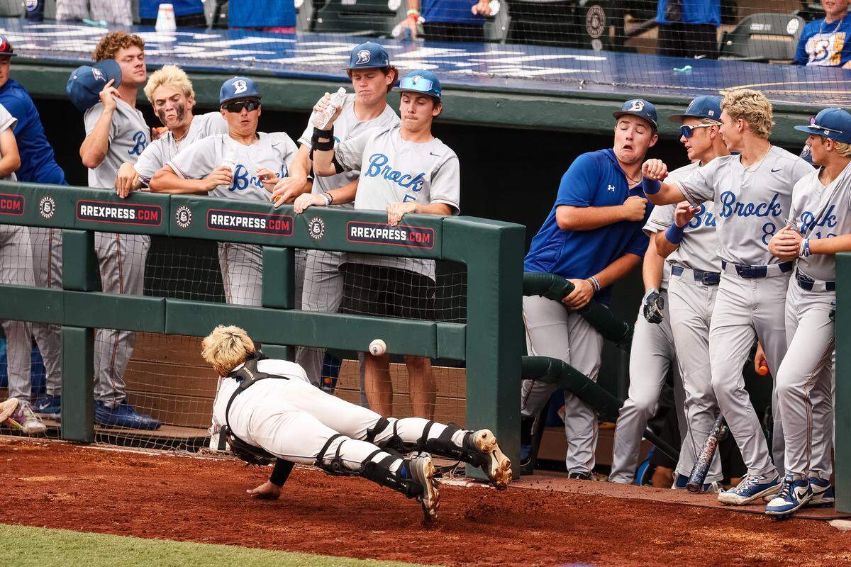 Brock players attempt to move out of the way as Robinson catcher Landon Armes dives for the ball in the UIL Class 4A Division II baseball state championship game on Friday, June 5, 2026, at Dell Diamond in Round Rock, Texas.