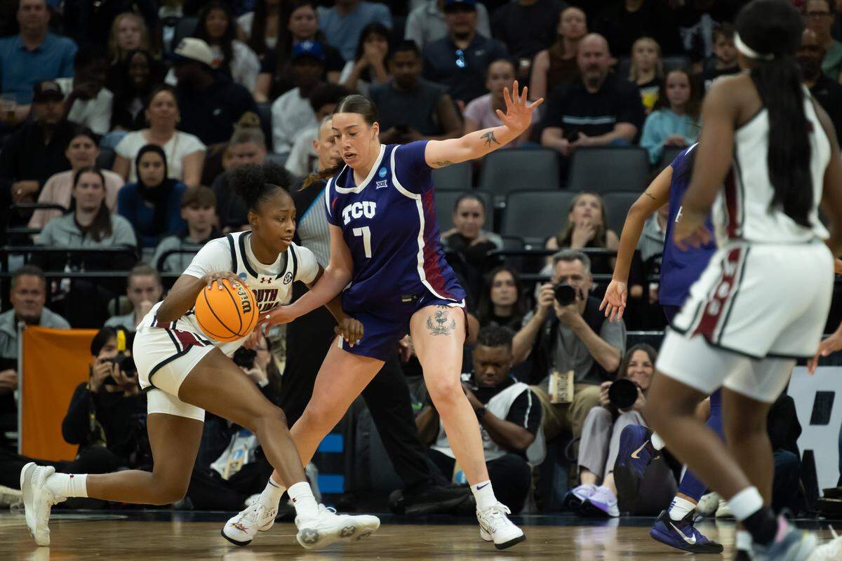 South Carolina Gamecocks forward Joyce Edwards (8) drives against Texas Christian University Horned Frogs forward Marta Suárez (7) during the NCAA Women’s Basketball Tournament Elite 8 at Golden 1 Center in Sacramento on Monday.