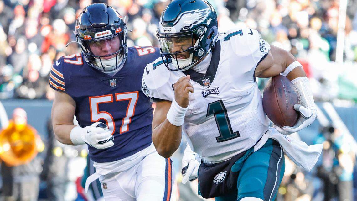 Philadelphia Eagles quarterback Jalen Hurts (1) runs with the ball during the first half of an NFL football game against the Chicago Bears.