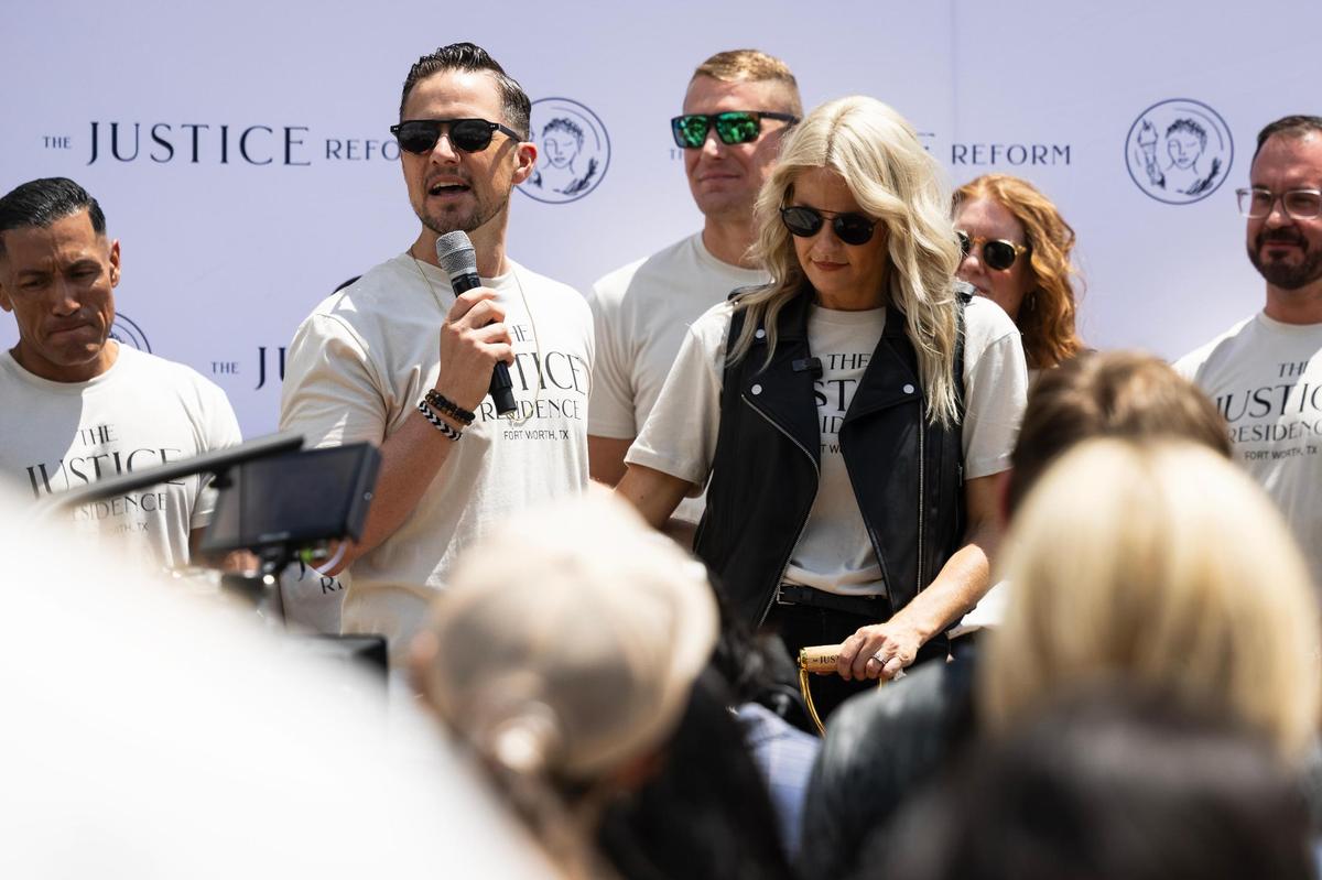 Mercy Culture co-lead pastor Landon Schott, left, speaksduring the groundbreaking of the church’s Justice Residences on Friday, May 9, 2025, in Fort Worth.