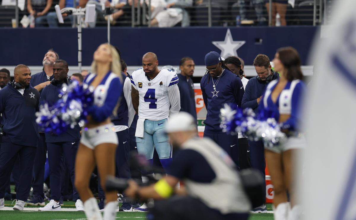 Dallas Cowboys quarterback Dak Prescott and others observe a moment of silence for conservative commentator Charlie Kirk before the game against the New York Giants on Sunday at AT&T Stadium in Arlington.