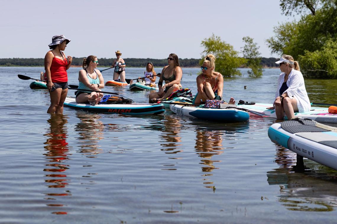 A group of kayakers and paddleboarders make their way back to the shore on Grapevine Lake at Oak Grove Park on May 31. Ava Moore, an 18-year-old U.S. Air Force Academy student, was kayaking on the lake when she was killed in a hit-and-run crash with a jet ski on Memorial Day weekend, authorities said.