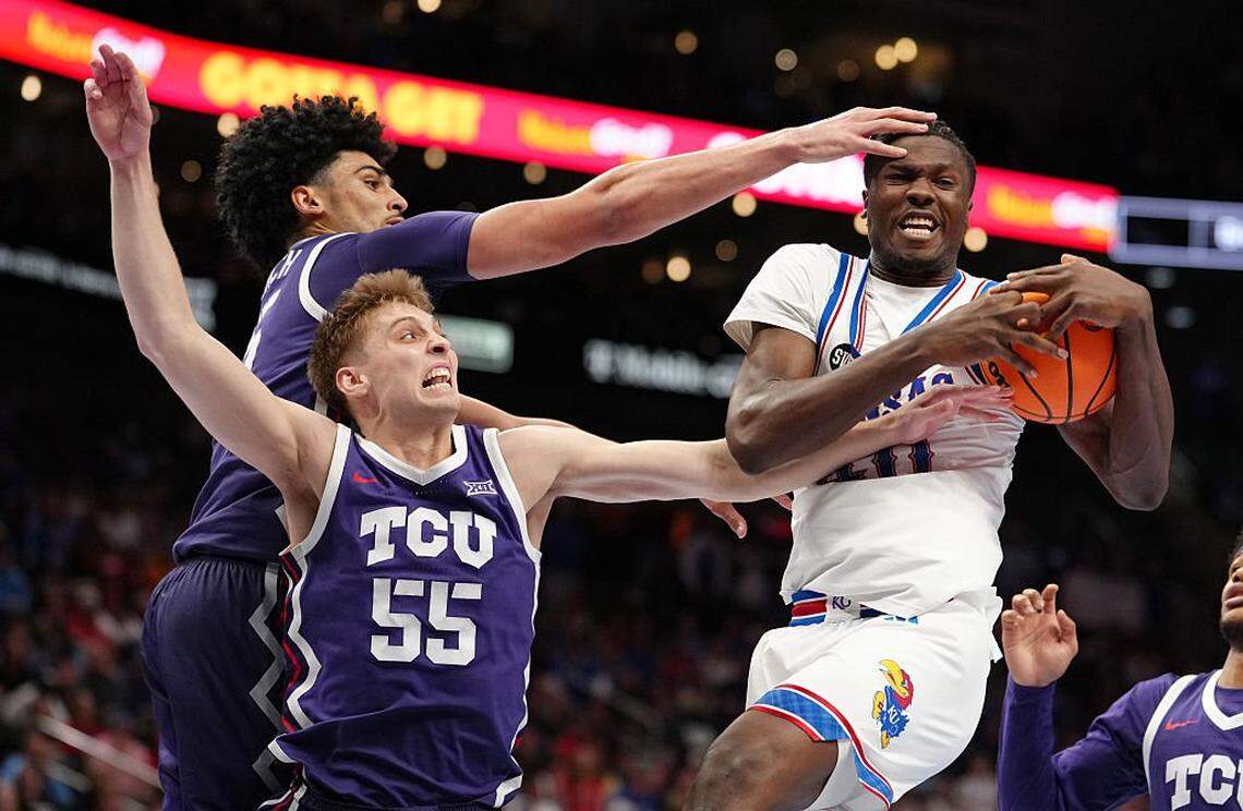 KANSAS CITY, MISSOURI - MARCH 12: Flory Bidunga #40 of the Kansas Jayhawks rebounds against David Punch #15 and Tanner Toolson #55 of the TCU Horned Frogs in the second half during the quarterfinals of the Big 12 Tournament at T-Mobile Center on March 12, 2026 in Kansas City, Missouri. (Photo by Ed Zurga/Getty Images)
