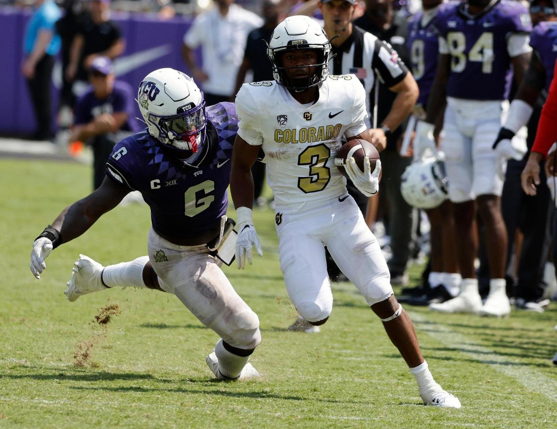 Colorado running back Dylan Edwards outruns TCU linebacker Jamoi Hodge (6) for the winning touchdown before the second half of a NCAA football game at Amon G. Carter Stadium in Fort Worth,Texas, Saturday Sept. 02, 2023. Colorado defeated TCU 45-42. (Special to the Star-Telegram Bob Booth)