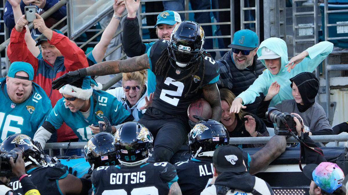 Jacksonville Jaguars safety Rayshawn Jenkins (2) celebrates with fans after an interception during the second half of an NFL football game against the Dallas Cowboys, Sunday, Dec. 18, 2022, in Jacksonville, Fla. (AP Photo/John Raoux)
