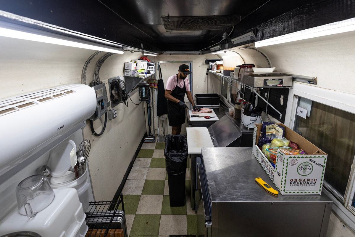 Zain Shafi, the owner of Sabar BBQ, trims the lamb ribs on the day before service in his trailer at 6 a.m. parked at the corner of E Vickery Street and S Main Street near downtown Fort Worth on Friday, Aug. 22, 2024.