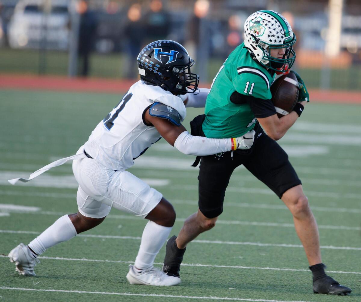 Southlake wide receiver Brock Boyd (11) is brought down by Hebron outside linebacker Aaron McCardell (21) during the UIL District 6A D2 Regional Semi-Finals football game at Joy and Ralph Ellis Stadium in Irving, Texas, Nov. 29, 2024.